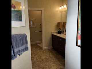 Guest bathroom from door.  Shower is to the left (not visible here), and sink to the right.  Door at the back is the "loo" or toilet room!  There is also a walk-in closet with door just past the towel rack on left.