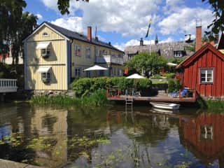 The yellow main house and red guest house