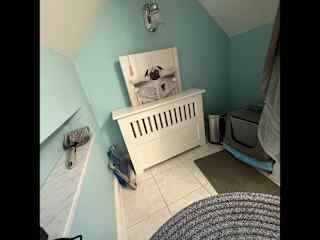 Kitty litter in corner of upstairs bathroom