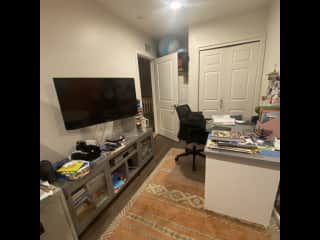 Office with TV and desk and sofa