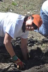 Digging holes for posts needed during the construction of an African village hut (home) in Kenya