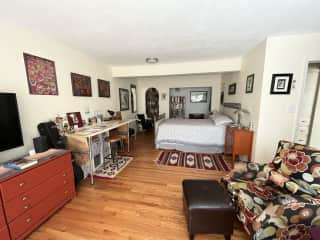 Spare bedroom with queen bed, combo tv room and craft table.