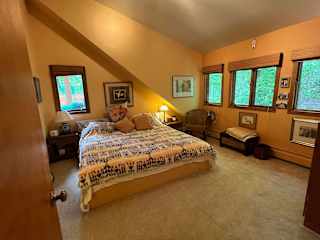 Guest bedroom with King bed for your use.  View of wooded backyard.