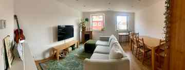Excuse the wonky pano shot. Our living room has a cozy couch and TV, an electric piano, and a fire-less fireplace.