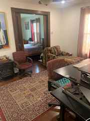 Work at the desk or relax on the sofa in our lovely old fashioned den with pocket doors and a Ben Franklin electric heater.