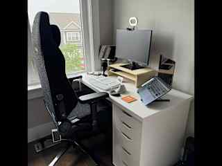 Office desk setup includes a keyboard and mouse a ring light, tablet holder, webcam, and a docking station to connect to your laptop.