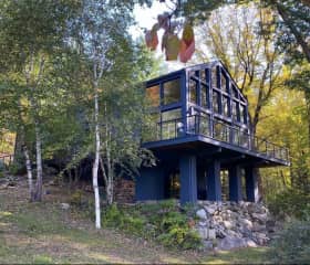 The mostly glass houses is cantilevered over a rock ledge, and has views of the 20 acre property.