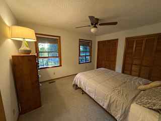 Guest Room with queen bed. Overlooks front porch and has a fan.