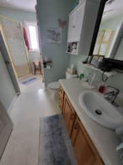 Bathroom has stand-alone shower as well as a bathtub.  Has entry from hallway and bedroom