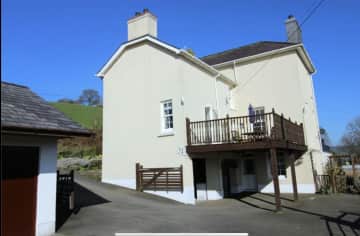 Rear of Gelli Lon with covered parking, large drive and 5 stable blocks