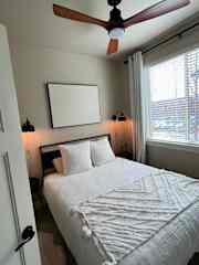 Guest bedroom on the 3rd floor with ceiling fan, cozy lighting and 55" TV.