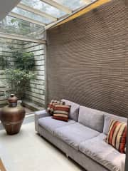 Sun room beside dining room. It's lovely to sit under this glass roof in the sunshine and equally, in the tropical rain