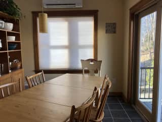 The dining area is off of the kitchen, with a door that leads to a back deck.