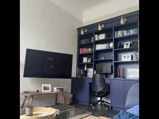 Tv room. Lots of books to read and a workstation. (1 of 2 desks with monitors)