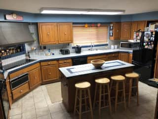 Spacious kitchen with 6 burner flat top and double oven.