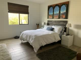 Guest bedroom complete with large TV and closet.