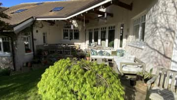 Covered porch with outdoor seating and large table