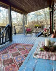 Front porch, which is actually the second level of our home. The ground level is where our artist studios are located. The views are better up here! There are two sitting areas with Adirondack-style chairs and two table areas for outdoor meals and fun.