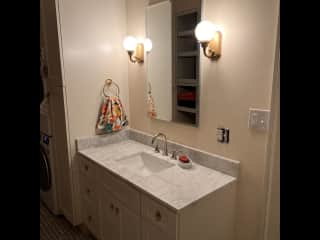 Newly remodeled full bathroom with washer/dryer.