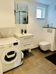 The bathroom includes washing machine and shower. We provide cleaning amenities if you would like to wash your clothes during your stay