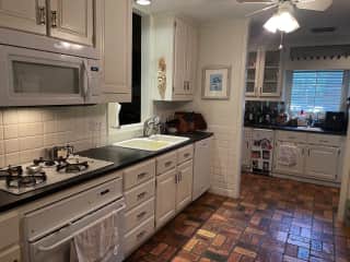 fully stocked kitchen with high  end furnishings 
washer and dryer in utility closet