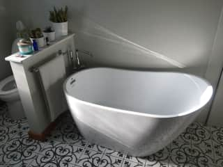 Remodeled bath with shower and tub.