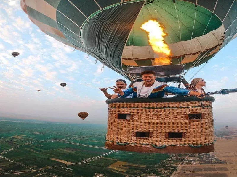 View from Luxor balloon gondola — Valley of the Kings and Hatshepsut Temple below