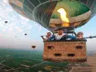 View from Luxor balloon gondola — Valley of the Kings and Hatshepsut Temple below