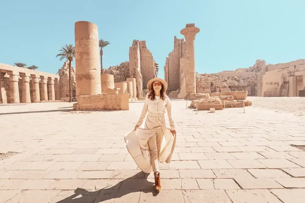 Solo female traveller exploring an Egyptian temple in modest comfortable clothing