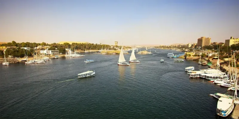 The Nile River at sunset with felucca sailboats near Aswan Egypt