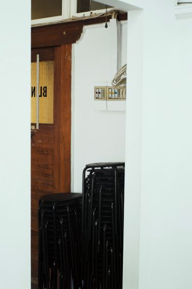 Chairs stacked in the corner of BLINDSIDE gallery