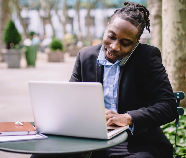 Image of cheerful businessman talking on smartphone in a park. Photo by Ketut Subiyanto from Pexels