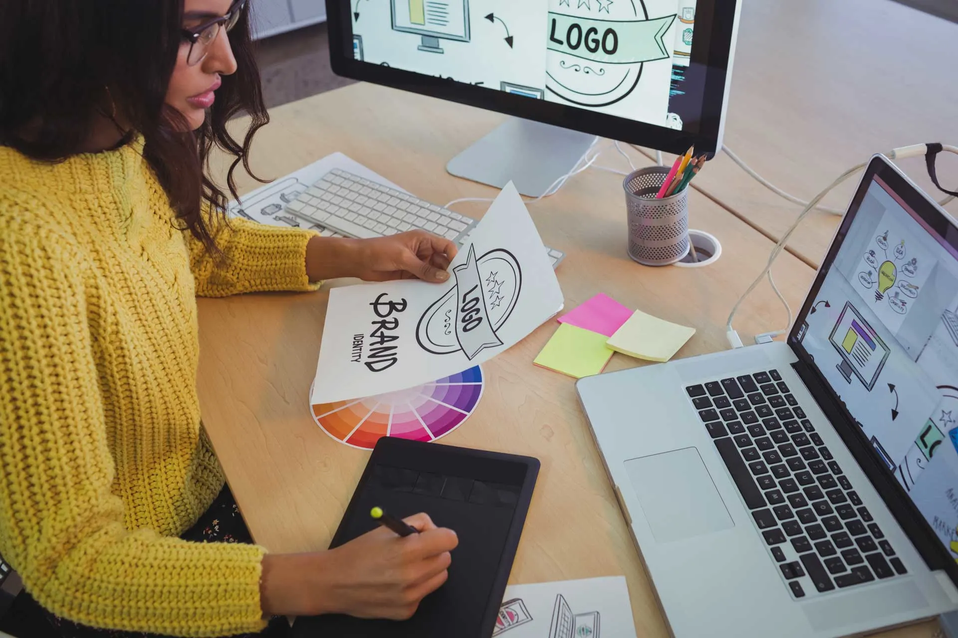 young-graphic-designer-working-at-office-desk-Z28SUAT.jpg