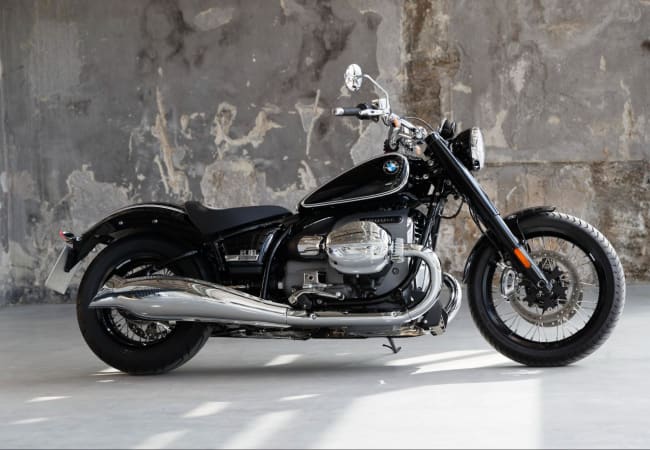 Black BMW R18 cruiser motorcycle in front of concrete wall backdrop | Twisted Road Motorcycle Rental