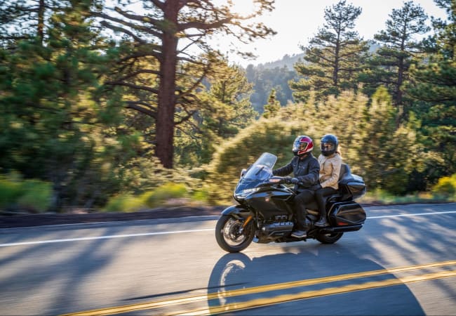 Black Honda Goldwing motorcycle on a highway in the countryside | Twisted Road Motorcycle Rental