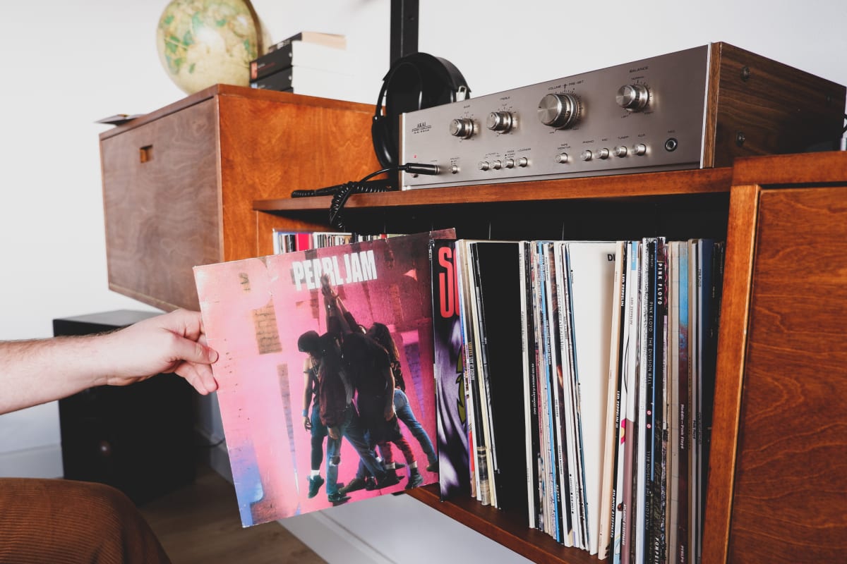 Person holding Pearl Jam's Ten on vinyl