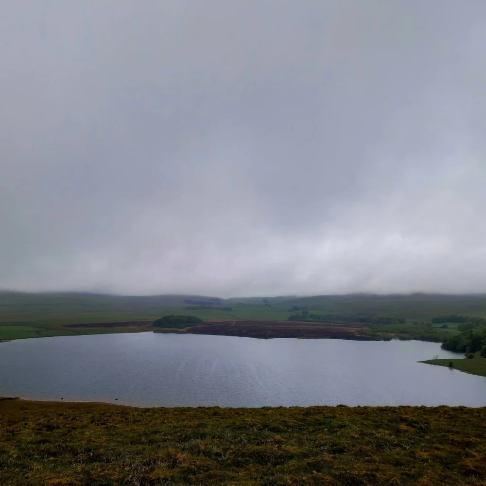 Malham Tarn and surrounding fells in low cloud