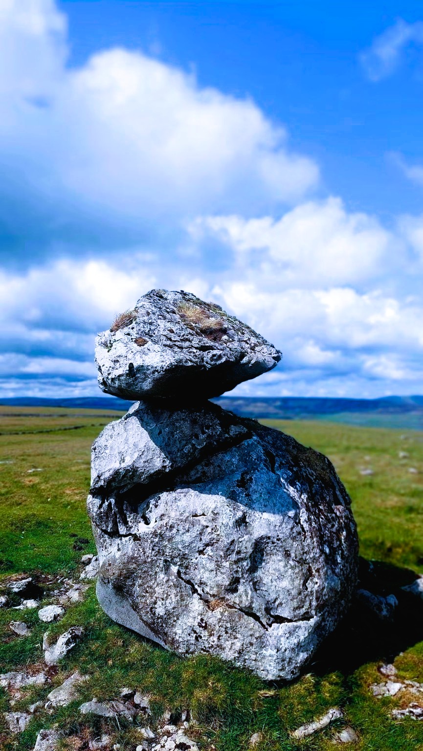 Two balancing limestone rocks against the sky