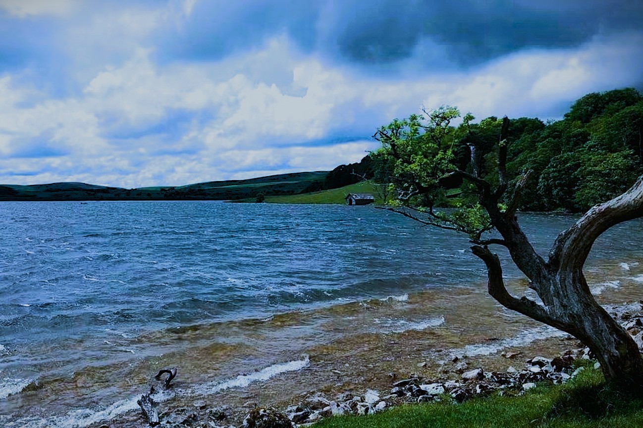 Malham Tarn shoreline beneath a dramatic sky