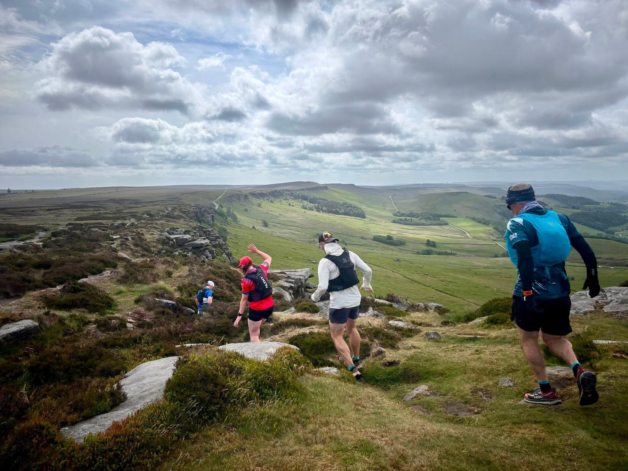 UTC runners descending a rocky hillside together