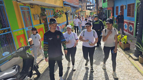 Group walking with a local guide through the colorful streets of Guatapé