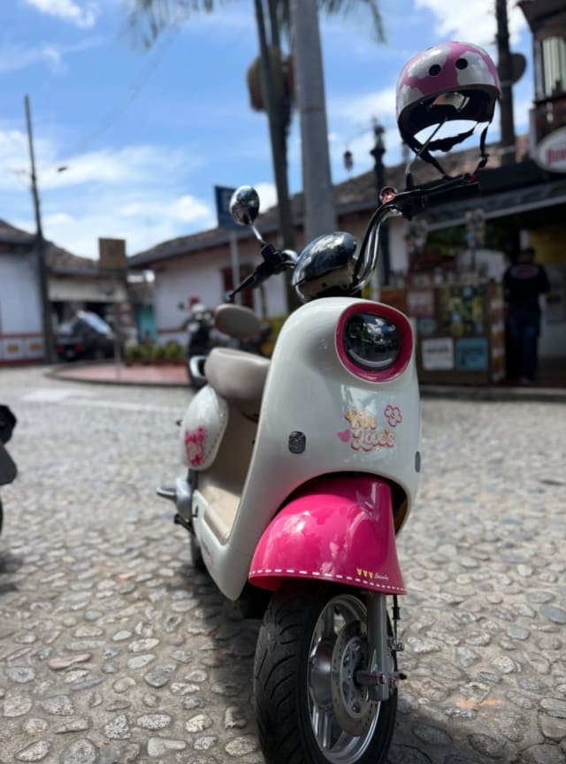 Pink electric scooter on a Guatapé street