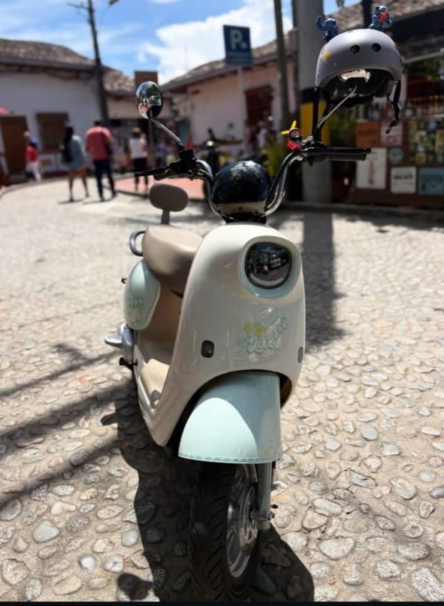 Mint green electric scooter on the cobblestones of Guatapé
