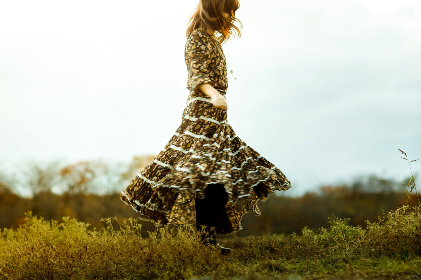 A woman wearing a flowing vintage floral dress