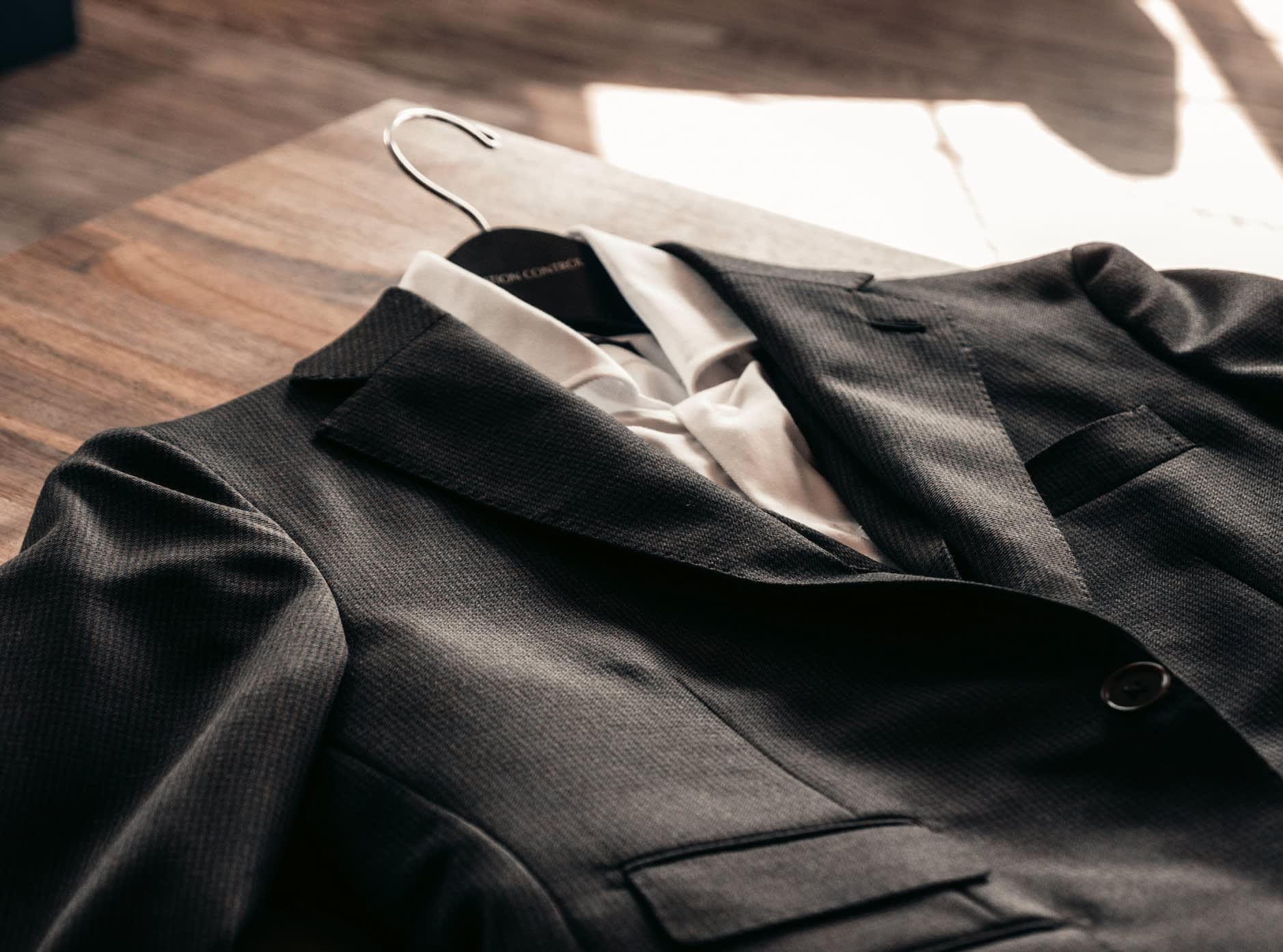 Black second-hand suit laid out ready to wear