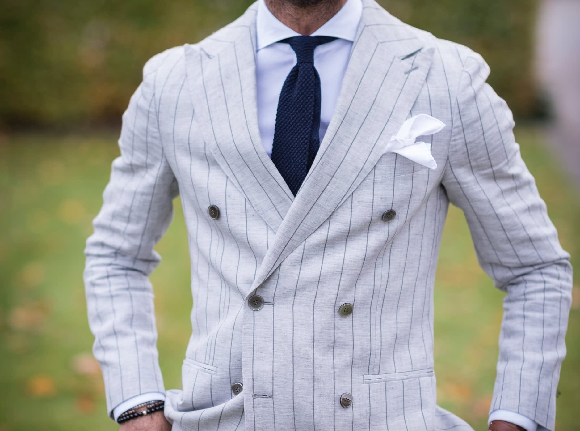 Groom wearing a grey second-hand pinstriped suit