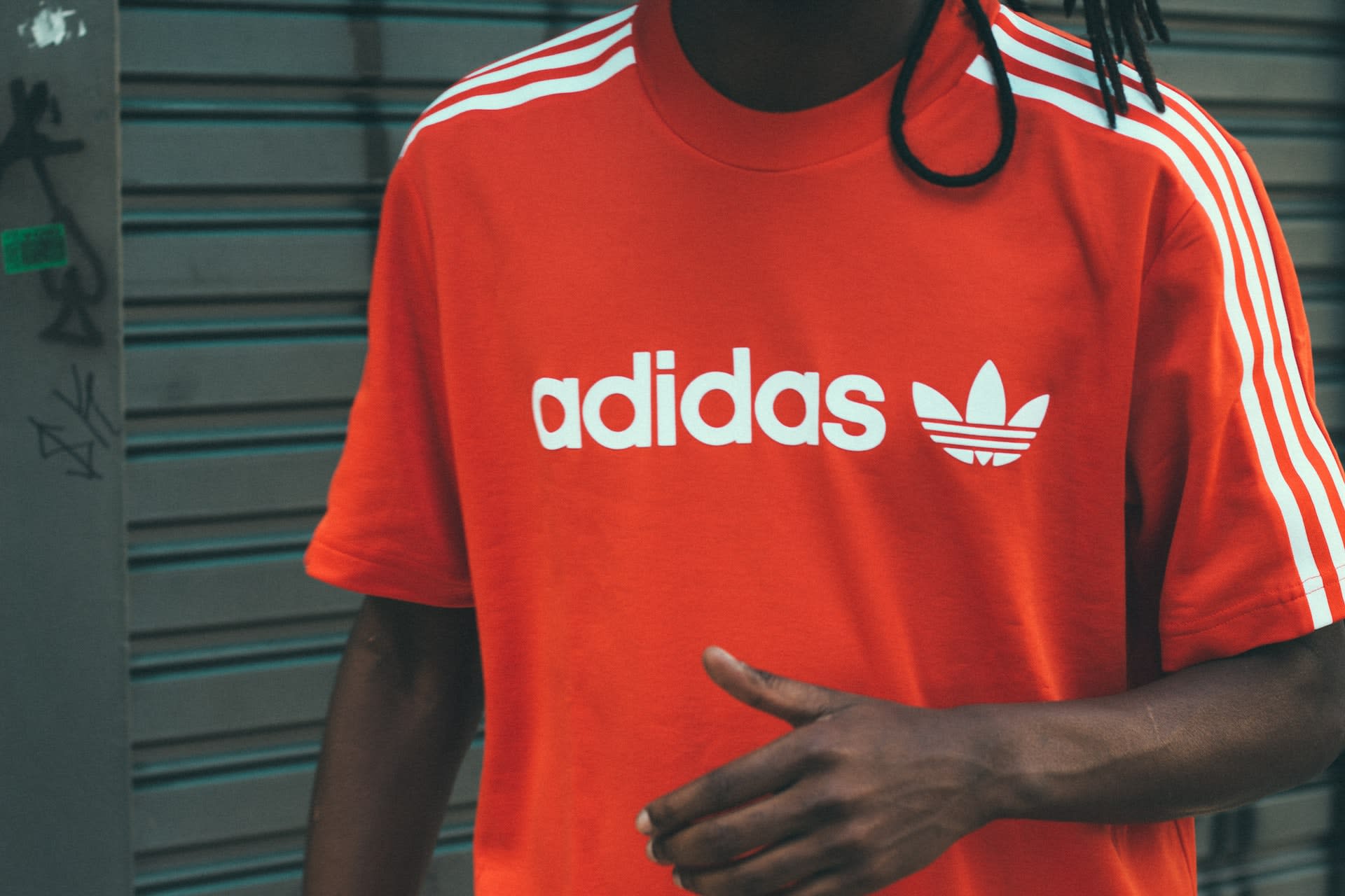 Man wearing red adidas top