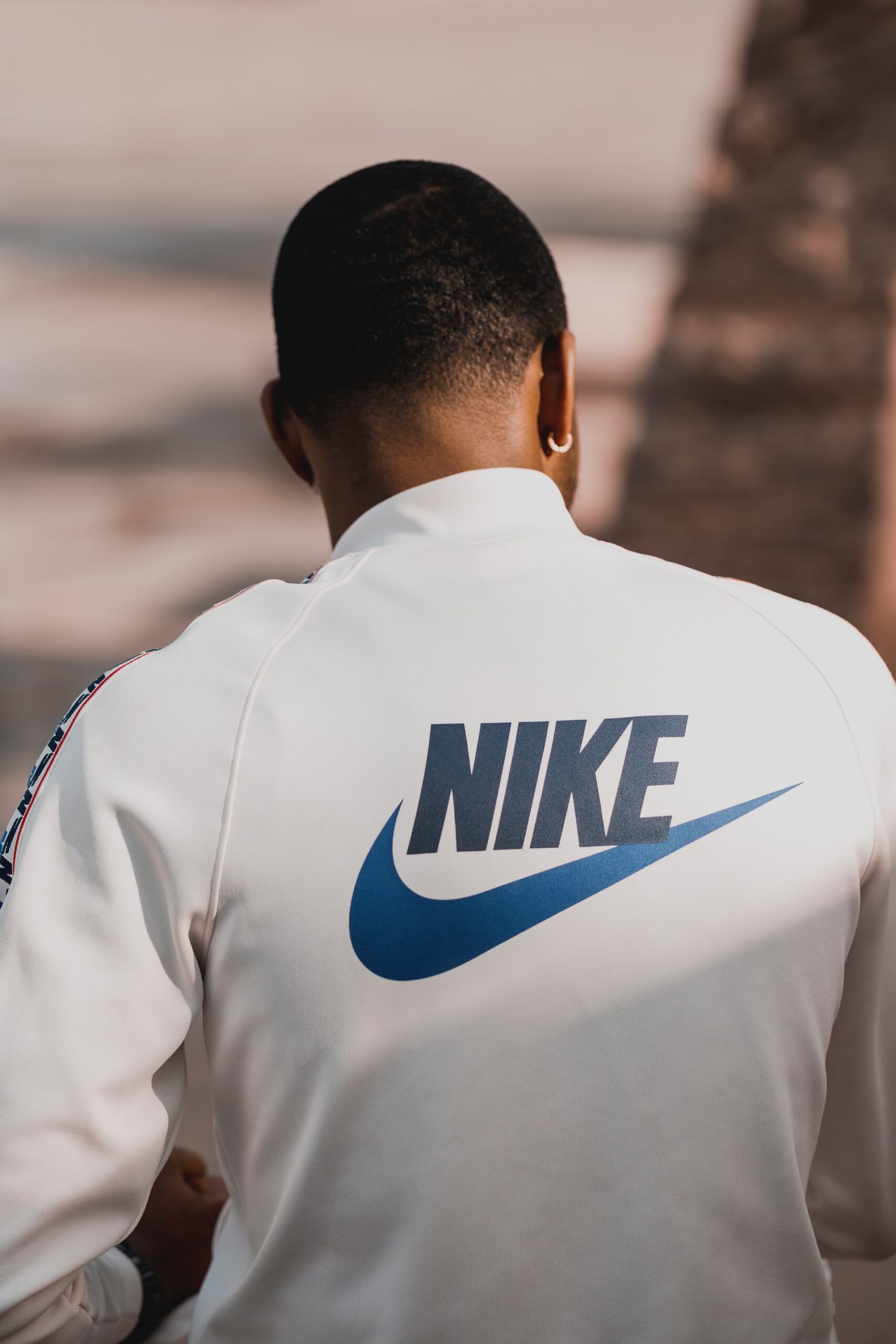 Nike logo on back of man's jacket