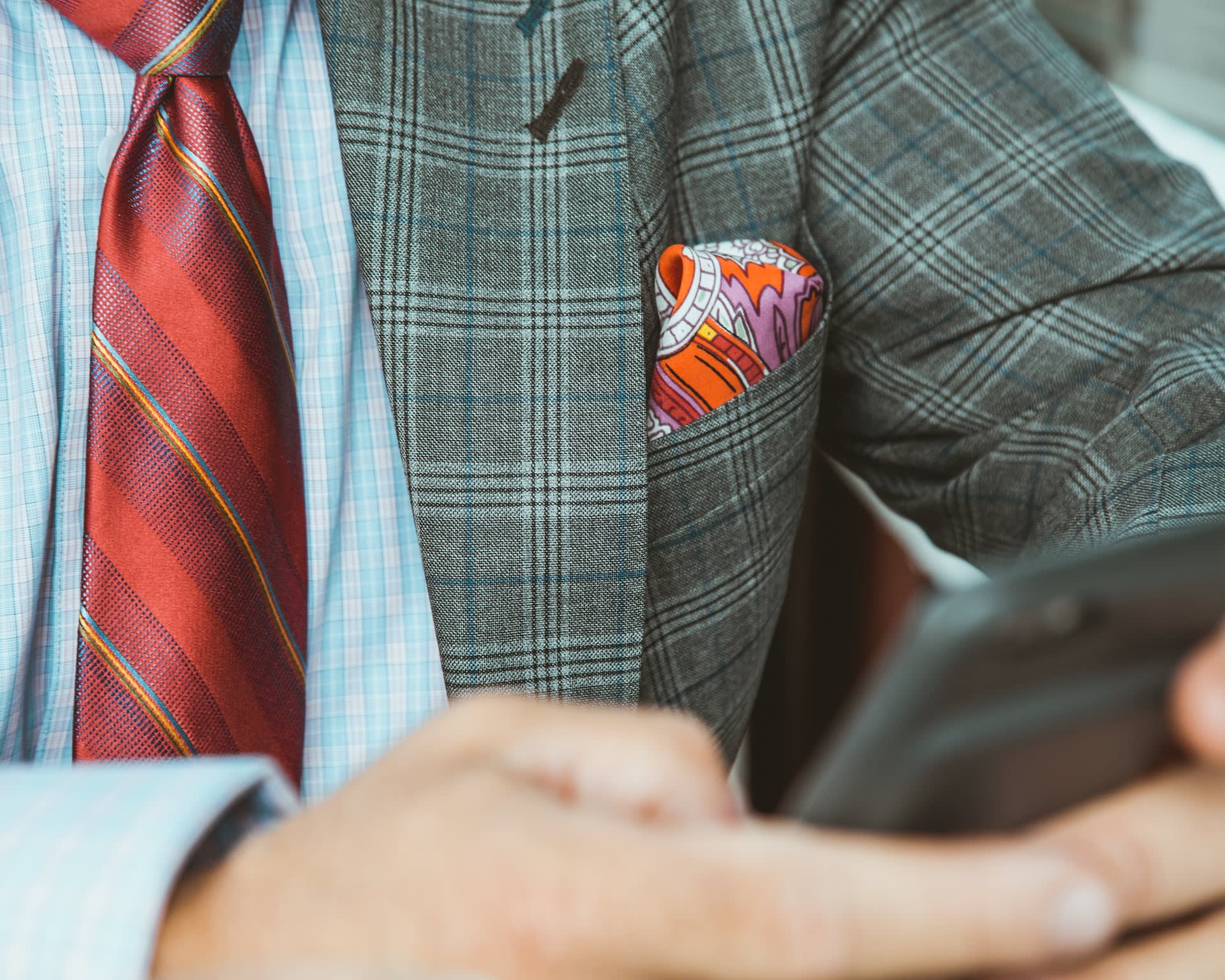 Close up of orange pocket square in a man's blazer pocket