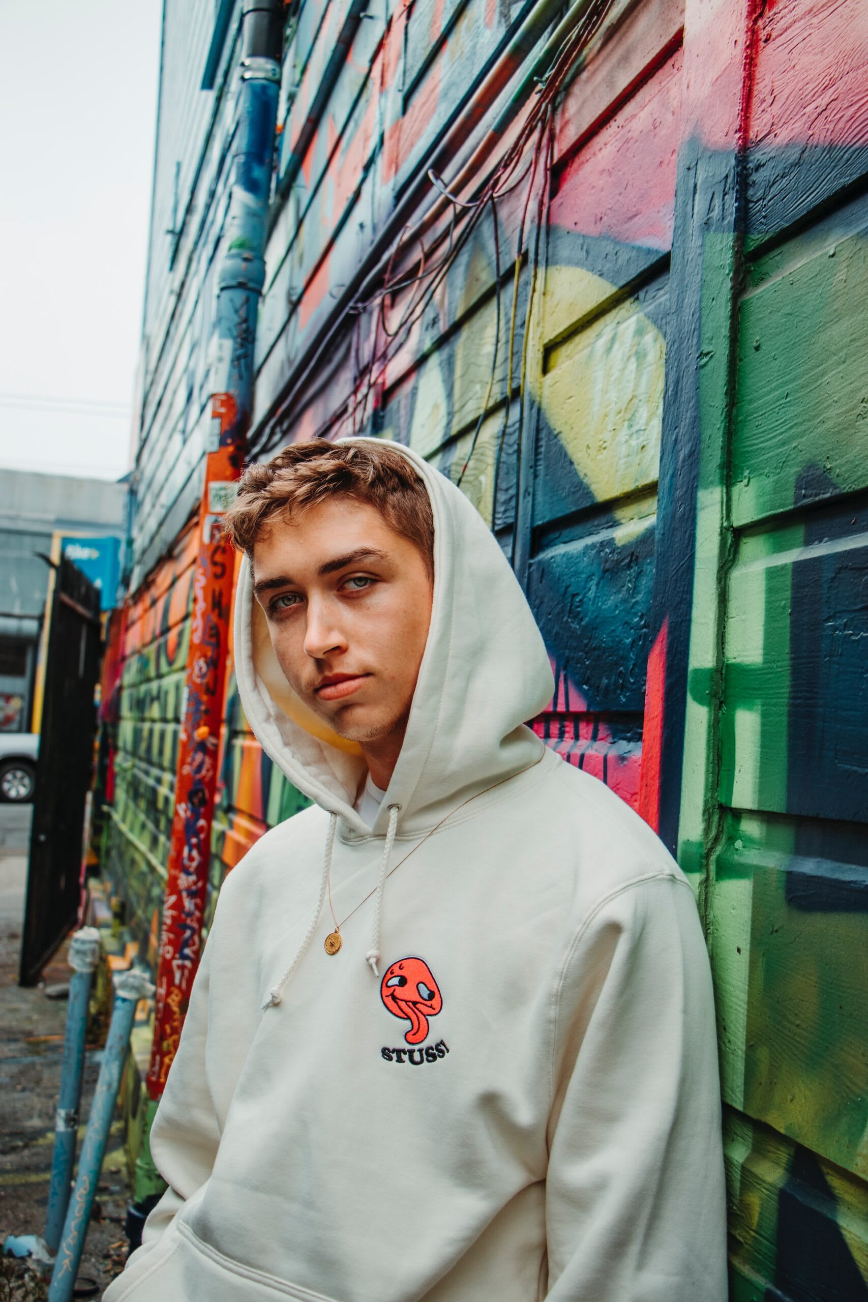 Man wearing a cream coloured second-hand Stussy hoodie